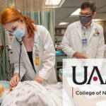A nursing student practices on a simulation dummy.