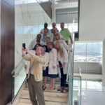Chancellor Cam Patterson takes a photo with graduating residents at the Baptist Health Medical Center-North Little Rock campus.
