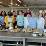 Members of the Donald W. Reynolds Institute on Aging and Arkansas Department of Human Services join in honoring Susan May as the institute's volunteer of the year.