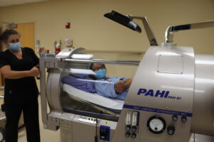 A MASH student poses in a CAT scan machine at Northwest Medical Center in Harrison.