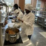 Students from Pathways Academy's Pine Bluff RAMP-UP program prepare spaghetti and meat sauce during a trip to UAMS' Culinary Medicine Kitchen.