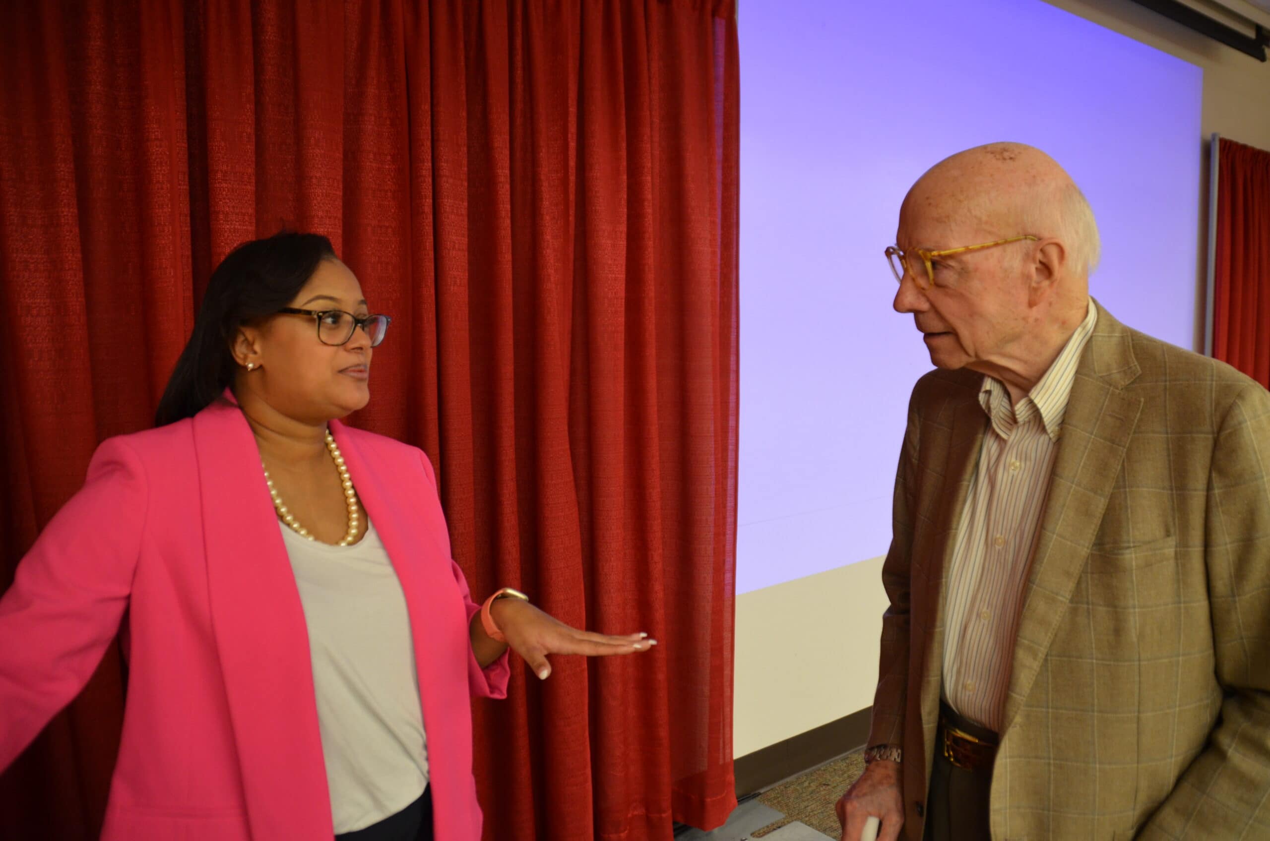 Joseph Bates, M.D., speaks to Samantha Wells, a doctoral student in the Fay W. Boozman College of Public Health, following her Grand Rounds presentation at the Arkansas Department of Health.