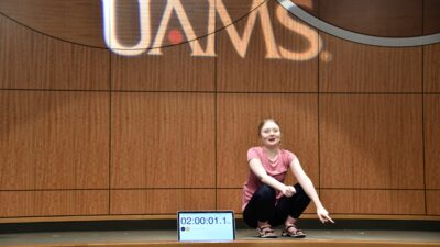 Gabby Rushing reacts at the 2-hour mark, setting the world record for longest-held deep squat.