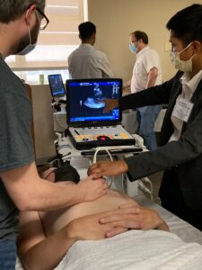 A student from the UAMS College of Medicine serves as a model patient during point-of-care ultrasound training.