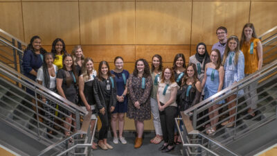 The recipients of College of Health Professions student scholarships gather on a staircase in the Rahn Building after the scholarship reception honoring them.