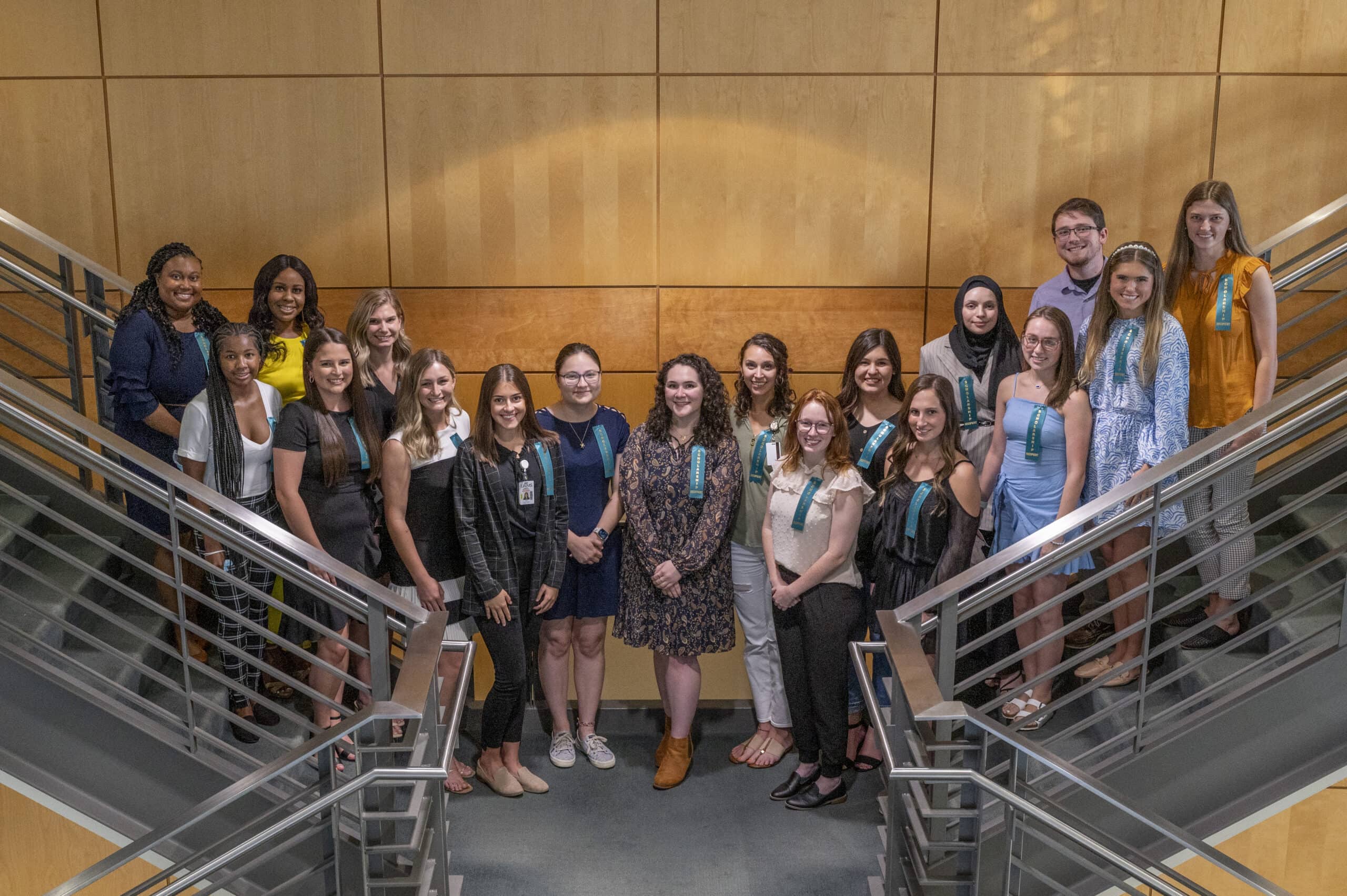 The recipients of College of Health Professions student scholarships gather on a staircase in the Rahn Building after the scholarship reception honoring them.