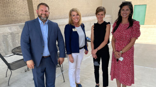Kristen McAllister, (second from right) director of the Northwest Arkansas Crisis Stabilization Unit, gives State Reps. Jim Dotson, Robin Lundstrum and Nicole Clowney a tour of the unit's garden area.
