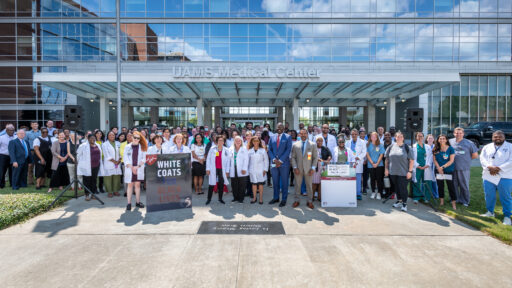 Participants stand together after the White Coats for Black Lives event at the University of Arkansas for Medical Sciences.