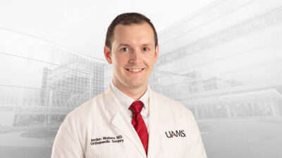 Jordan Walters, M.D., in white coat