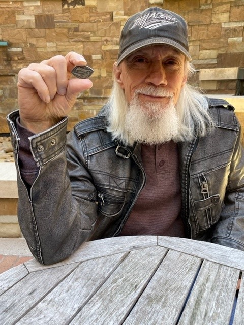UAMS Lung Cancer Survivor holds the Seed of Hope token he received when his cancer treatment ended