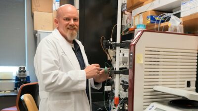 Jon Blevins, Ph.D., in his lab with a Cytiva ÄKTA pure chromatography system used for purification of proteins in his research of tick-borne relapsing fever.