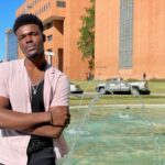 Andrew Igbokidi stands by the fountain outside UAMS