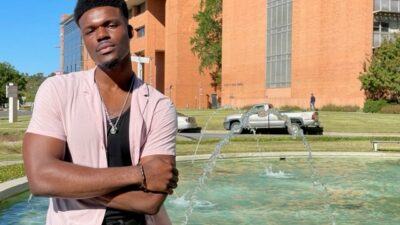 Andrew Igbokidi stands by the fountain outside UAMS