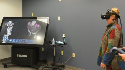 Arkansas State Representative Denise Garner gets ready to try out the virtual reality anatomy equipment on the UAMS Northwest Regional Campus during a visit to the campus with fellow state representatives.