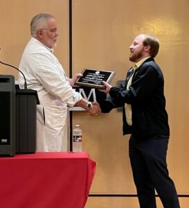 Christopher Godwin receives his achievement award.