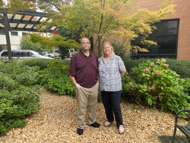 Terry Fortner stands next to his wife, Robbie, outside UAMS