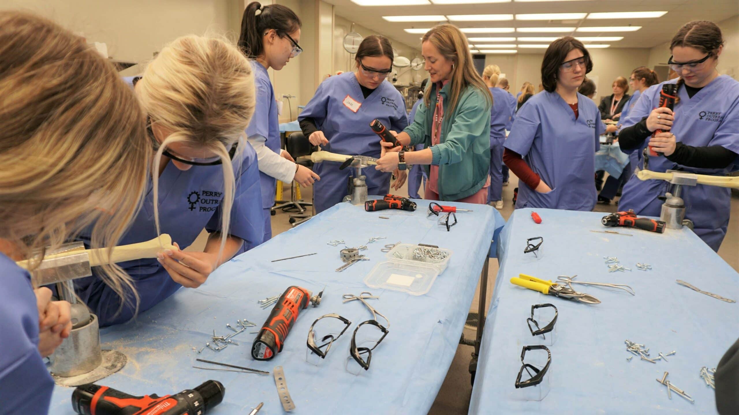 Theresa Wyrick, M.D., (center) instructs high school students during a hands-on session of the Perry Outreach Program workshop at UAMS.