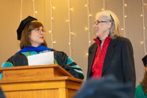Dr. Sherry Muir (left), chair and founding director of the occupational therapy program, enjoys the moment with Dr. Fran Hagstrom, associate dean of international education and the University of Arkansas.