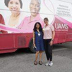 Gwendolyn Bryant-Smith, M.D., and Crystal Smith stand next to the UAMS MammoVan during a Midsouth Black Expo event in 2022.