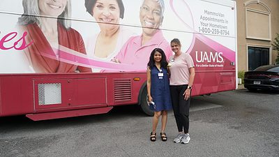 Gwendolyn Bryant-Smith, M.D., and Crystal Smith stand next to the UAMS MammoVan during a Midsouth Black Expo event in 2022.