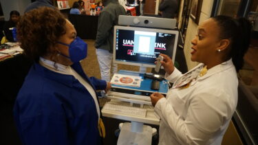 Alyssa Robinson, RN (right), representing the UAMS Institute for Digital Health & Innovation, demonstrated telehealth technologies during the expo. 