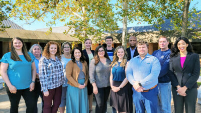 The faculty and staff of the Department of Physician Assistant Studies take a moment for a group photo outside on the west side of the Little Rock campus of UAMS.