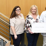 Samantha Lawson, left, Michelle Hill, Ryan Toliver and Spencer Hughes present a mock check celebrating the $11,786 that PA students raised last year for the Arkansas Food Bank.