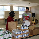 Josh Harris, executive director of Well Fed, helps a patient on the first food delivery day for Good Food Rx.