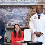 State Sen. Aaron Pilkington, left, Gov. Sarah Huckabee Sanders, and Edward Williams on May 5 just after the official signing of Act 303.