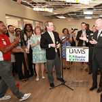 UAMS and Baptist Health leaders cut the ribbon to officially open a new cancer clinic on the Baptist Little Rock campus