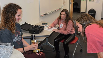 A student participates in the grip challenge at the OT Olympics