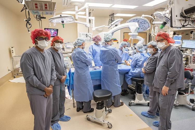 The UA I3R team (gray scrubs) from the University of Arkansas, Fayetteville, was available to consult on the surgery as needed. (photo by Evan Lewis)