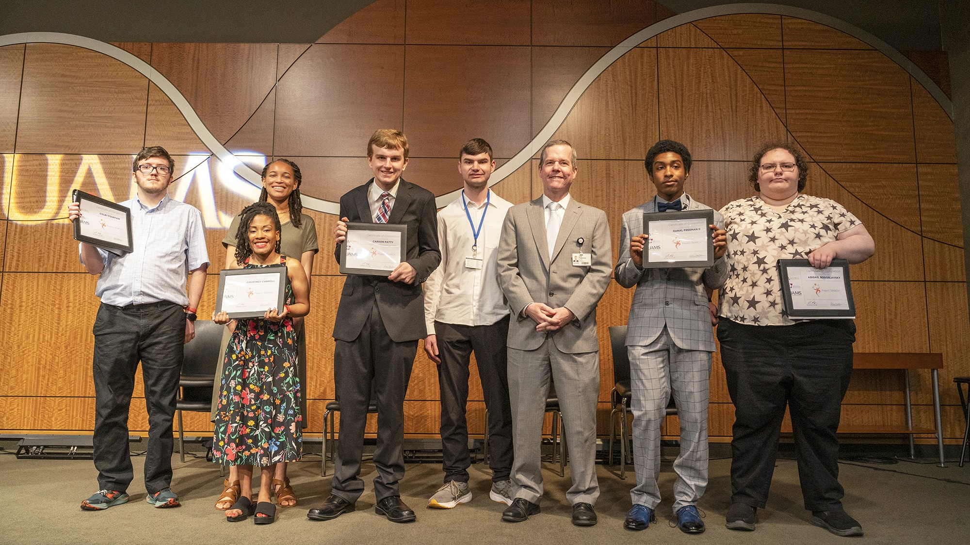 UAMS Chancellor Cam Patterson, third from right, stands with UAMS Project SEARCH 2023 graduates, left: Colby Fountain, Jakiyah Williams, Courtney Carroll, Carson Patty, Chase Caterbury, Patterson, Ranal Freeman II and Abby Bogoslavsky