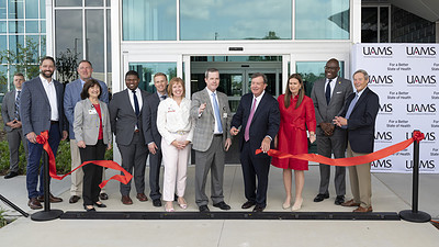 Smiles abound as C. Lowry Barnes, M.D., chair of the Department of Orthopaedic Surgery, flanked by Chancellor Cam Patterson, M.D., MBA and Gov. Sarah Huckabee Sanders, cuts the ribbon in front of The Orthopaedic & Spine Hospital. Also pictured (from L-R) Jake Nabholz, CEO of Nabholz Construction; Greg Cockman, CEO of Cromwell Architects Engineers; Stephanie Gardner, Pharm.D., Ed.D., UAMS senior vice chancellor for Academic Affairs, provost and chief strategy officer; Johnathan Goree, M.D., UAMS director of Interventional Pain Management Services; Paul Stover, UAMS assistant vice chancellor for Clinical Administration; Michelle Krause, M.D., senior vice chancellor for UAMS Health and CEO, UAMS Medical Center; Patterson; Barnes; Huckabee Sanders; Little Rock Mayor Frank Scott Jr.; and Morril Harriman, chair of the U of A System Board of Trustees.