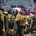 Graduates of the University of Arkansas for Medical Sciences walk in a line at the 2023 commencement ceremony.