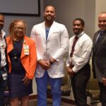 Adam Johnson (from left), M.D., Ph.D.; Sharanda Williams, M.A.; John Ukadike, D.O., MPH; Wayne Bryant Jr., M.D.; and William Greenfield, M.D., stand for a group photo after the Black Men in Medicine panel discussion.