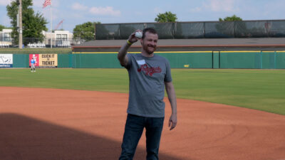 Leslie Stone, M.D., MPH, stands on the field before the Arkansas Travelers' May 30 game at Dickey-Stephens Park.