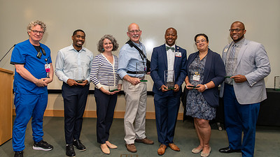 Seven of the Excellence in Mentoring Award recipients pose for a photo after the June 14 ceremony.