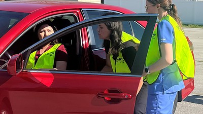 Occupational Therapy professor Kandy Salter works with OT students on how to properly check a person's car for their specific fit.