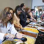 Gloria Richard-Davis, M.D., executive director of the UAMS Division for Diversity, Equity and Inclusion, serves food to staff and faculty members during the Juneteenth celebration.