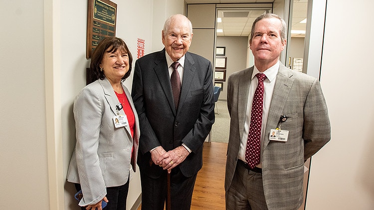 Provost Stephanie Gardner, left, William Slagle and Chancellor Cam Patterson visit with each other in the hallway in the remodeled area, which added to the space of the Oral Health Clinic. A new conference room nearby was named for Slagle.