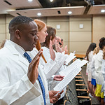 After putting on their white coats, physician assistant students in the Class of 2025 recite the Professional Oath.