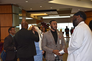 Graduates and faculty members gather during a reception held after the ceremony.