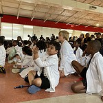 Children from Pathways Academy watch as their fellow students perform STEM-themed songs during a closing ceremony for summer programs at Carver STEAM Magnet Elementary School in Little Rock.
