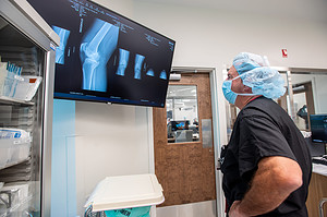 Barnes reviews detailed images of Frazier's knee before surgery.