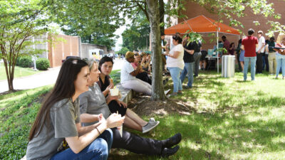 Dozens of research students and faculty line up for scoops of Loblolly ice cream in the courtyard of the Biomed 2 building.