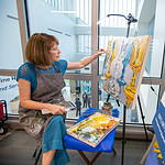 Artist Shelley Gentry works on an acrylic painting as the surgical hospital's first artist-in-residence.