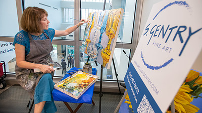 Artist Shelley Gentry works on an acrylic painting as the surgical hospital's first artist-in-residence.