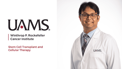 Male doctor in a physician's white coat standing in front of a white background