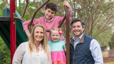 Cam Deacon (right) with his wife, Lauren, and their two children.